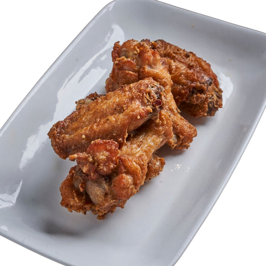 A plate with three golden-brown, breaded chicken wings on it, presented against a white background.